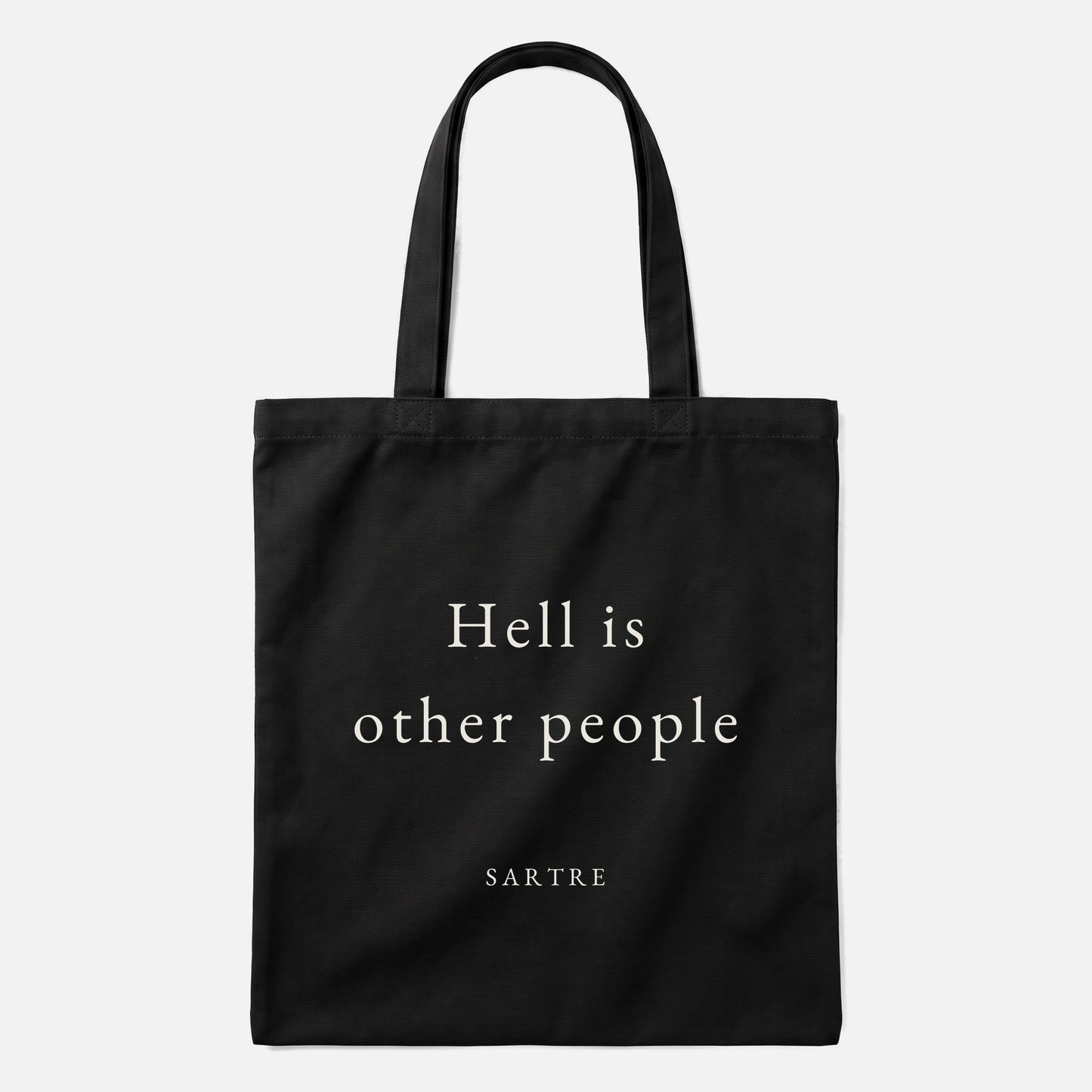 Sartre quote tote bag by Subtext – cream text on a black canvas tote with zip closure, front view.