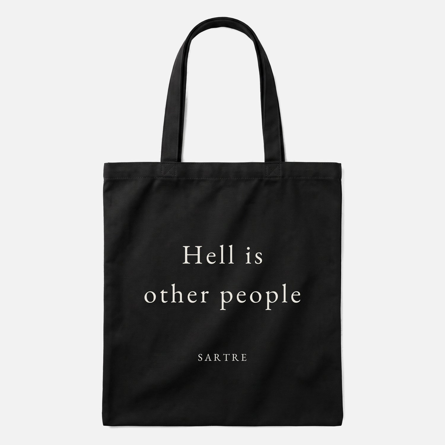 Sartre quote tote bag by Subtext – cream text on a black canvas tote with zip closure, front view.