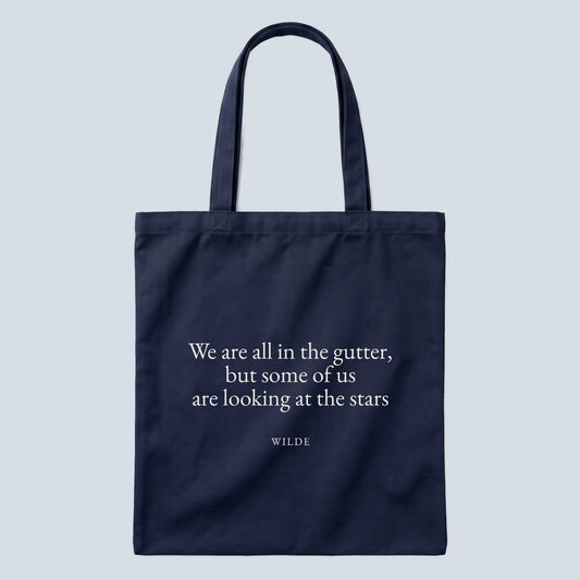 Wilde (Stars) quote tote bag by Subtext – cream text on a navy canvas tote with zip closure, front view.